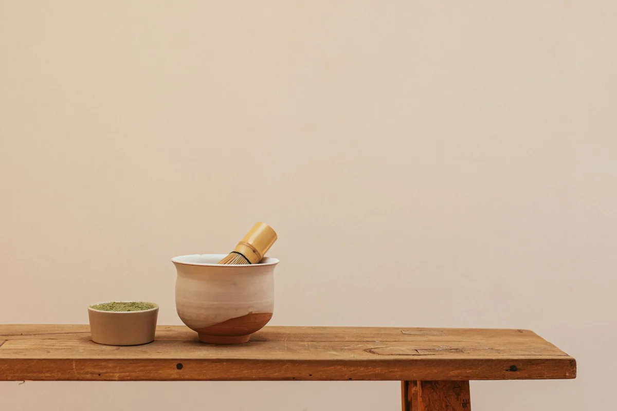 A wide matcha bowl with a bamboo whisk