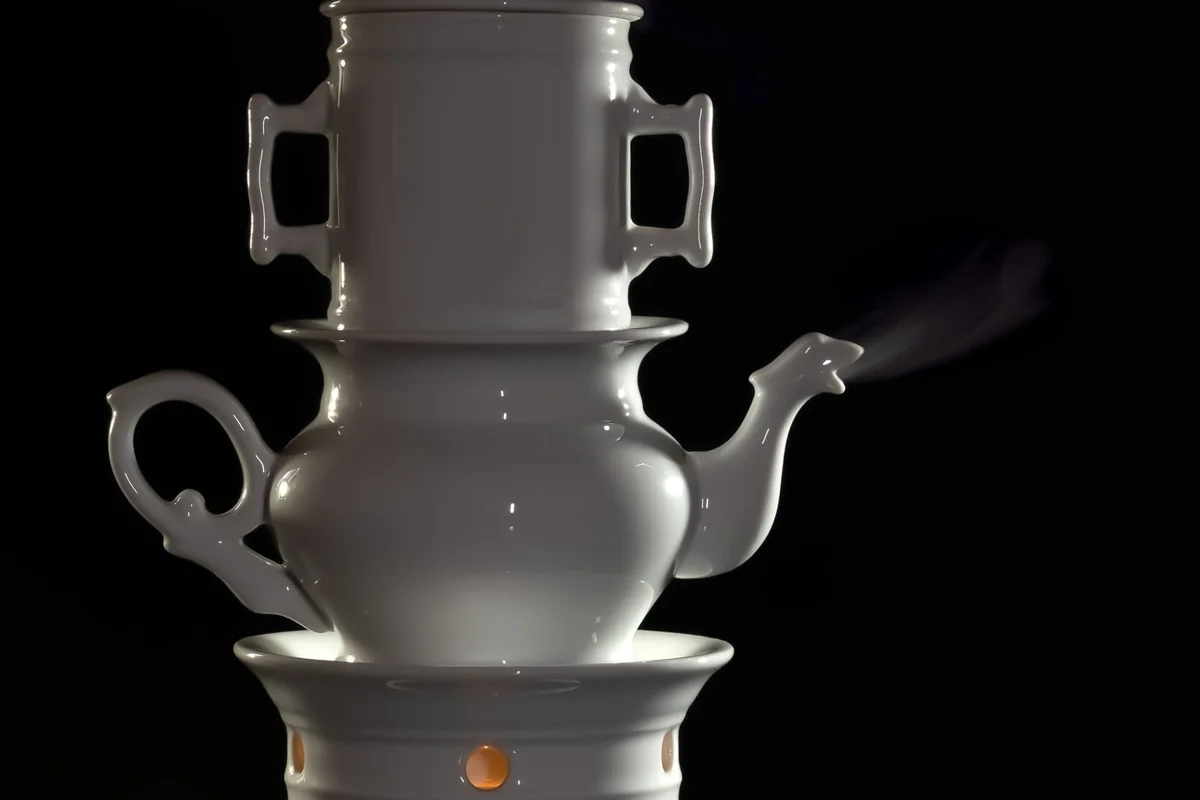 A porcelain tea warmer with a teapot and an opening for a tealight