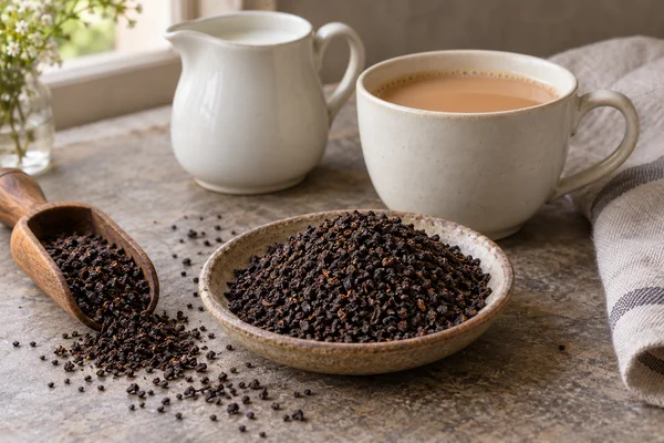 Robust broken black tea beside a breakfast cup and a milk jug
