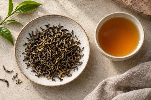 Dark second flush Darjeeling leaves with golden tips and amber tea