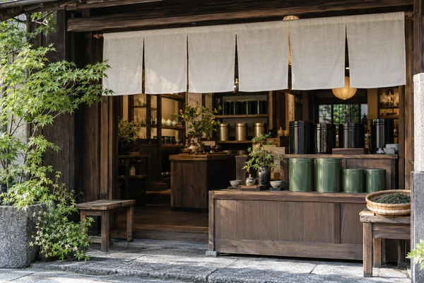 Japanese tea shop frontage with plain noren and carefully arranged tea canisters